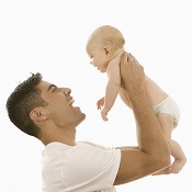 Man holding up Daughter