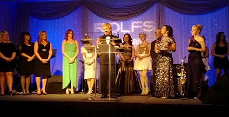 Rolf making a statement after receiving his award. His staff stands behind him.