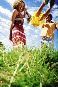 Parents Playing with Daughter in a Park