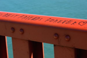 Guard rail along the east sidewalk of the Golden Gate Bridge in San Francisco, California. A permanent marker inscription reads "Best friends forever ♥".