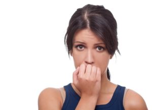 Head shot of worried woman over white background