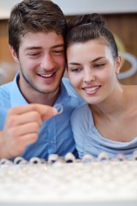 happy young romantic couple in love buy jewelry ring in luxury store