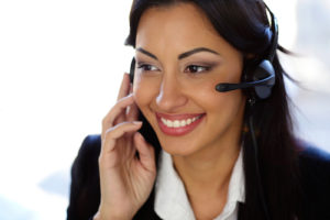 Smiling female customer support operator with headset