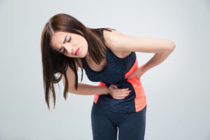 Fitness woman having pain in stomach