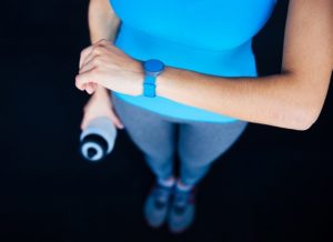 Woman with activity tracker and shaker