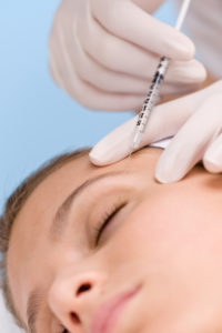 Botox injection - woman in cosmetic medicine treatment