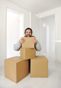 Man with boxes moving in new house