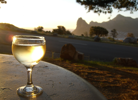 A glass of white wine outdoors.