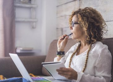 woman taking notes while working