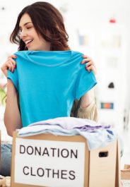 Mother and daughter preparing toys and clothes to donate for charity.