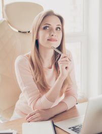 Portrait of relaxed pretty thoughtful pondering minded beautiful stunning clever smart creative inspired entrepreneur dreaming about weekend and vacation don't want to work sitting at the table