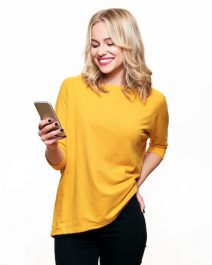 Gorgeous smiling woman looking at her mobile phone. Woman texting on her phone, isolated over white background.