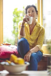 Mature woman is having the morning coffee at home