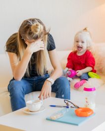 Exhausted mother with little child