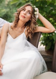 Newlywed coupe sitting on a sofa angry at each other in a middle of an argument. Young couple problem concept outdoor.