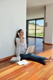 beautiful young woman relax and work on laptop computer while working on laptop computer and read book at home